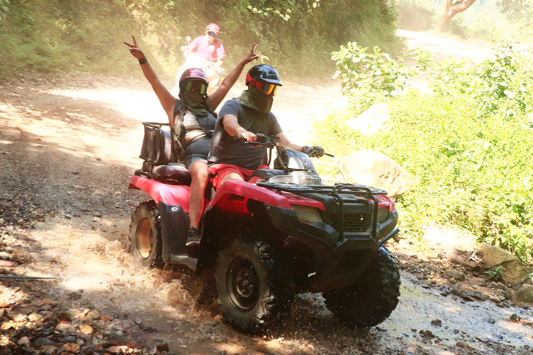 1. A happy family riding an RZR, enjoying an adventure on the trails of Puerto Vallarta.