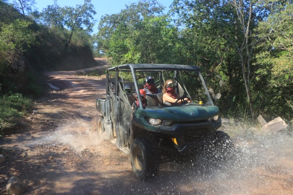 Things to do in hot springs; Tourists driving an ATV through scenic landscapes, enjoying the thrill of adventure in Puerto Vallarta's natural beauty.