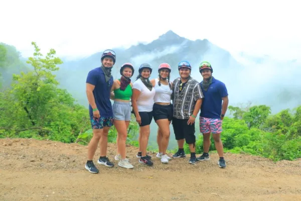 A family posing together, capturing memories during exciting Puerto Vallarta activities like outdoor excursions.