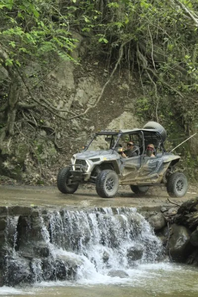 An RZR racing through the tropical jungle of Puerto Vallarta during a vibrant nature excursion.