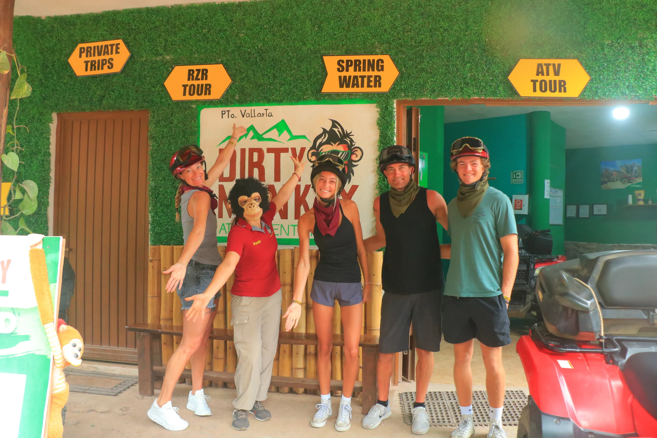A group of people participating in the family tours poses with smiles in front of the tour meeting point, ready to start a new adventure.