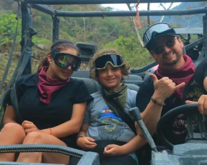 Three people enjoy their time together inside a RZR in the middle of nature, capturing a special moment of their rzr adventure.