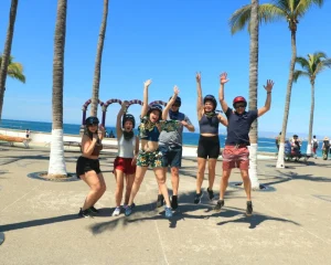 Sharing joyful moments with friends on the beach under the palm trees is part of the things to do in Puerto Vallarta.