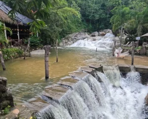A series of small waterfalls and a stone path across the river reflect one of the natural landscapes you can discover when you Travel to Puerto Vallarta.