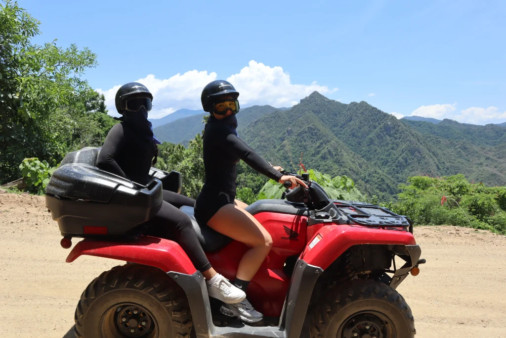 Two riders enjoy an ATV adventure in the mountains, often making travelers wonder: do you need a passport to go to Puerto Vallarta.
