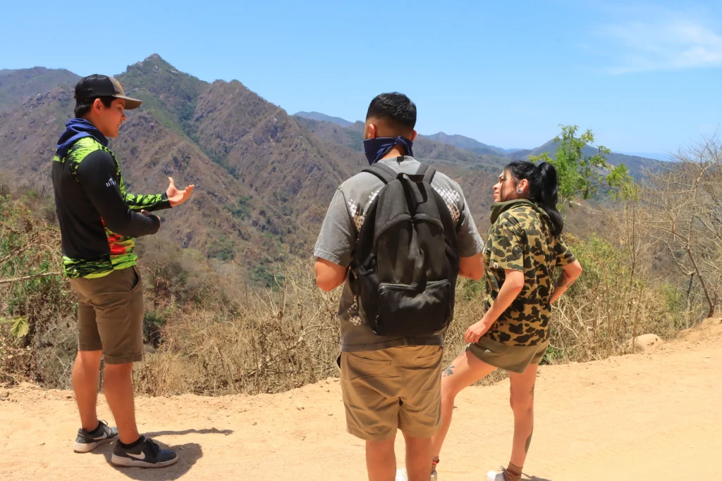 Adventurers admire a mountain landscape from above, part of an Extreme adventure Puerto Vallarta route.