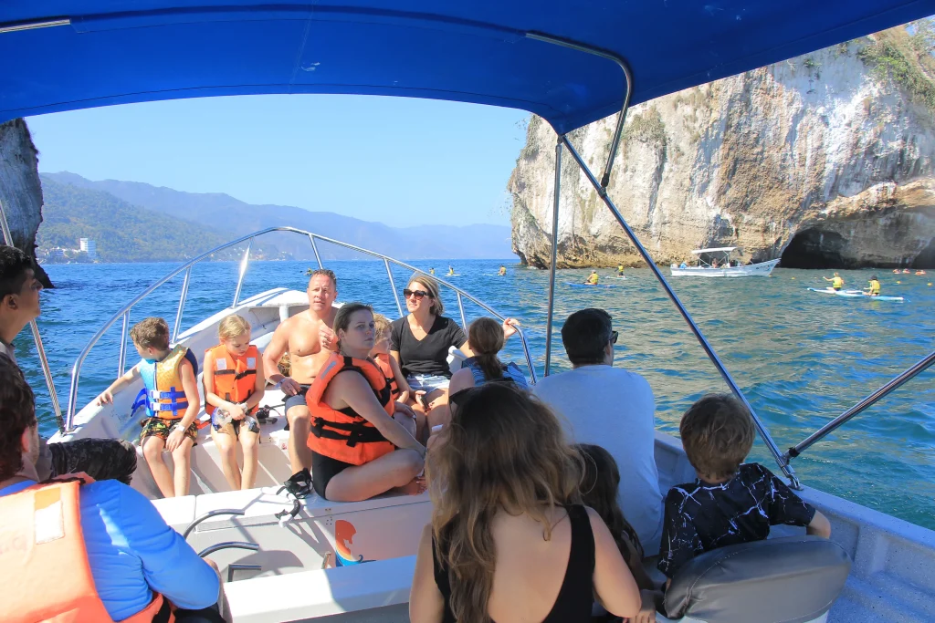 Kids in life jackets enjoy a boat ride with their parents, a classic choice among the things to do in Puerto Vallarta with kids.