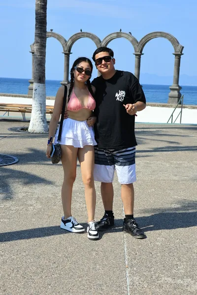 A happy couple posing for a memorable photograph during a boat ride in Puerto Vallarta, reflecting romance and shared experiences.